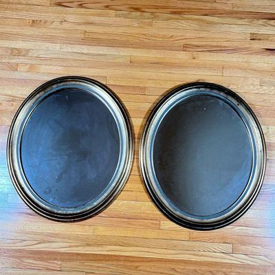 (2pc) Pair of Oval Gilt Mirrors | Pair of oval-shaped mirrors with gold gilt details along the frame/rim. - h. 26 x w. 22 in

