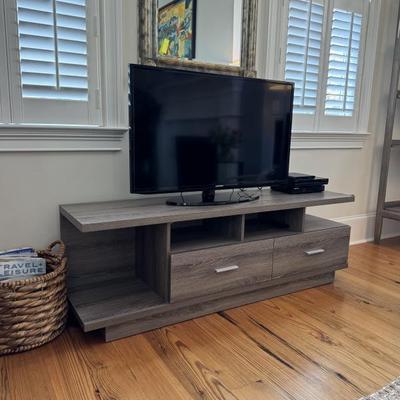 Contemporary entertainment console measures60” wide x 15.5” deep x 30” tall. TV NOT FOR SALE!