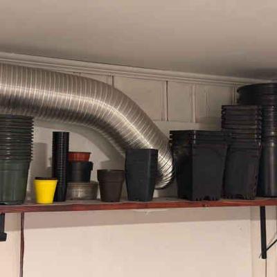 Shelf Of Plastic Planters
