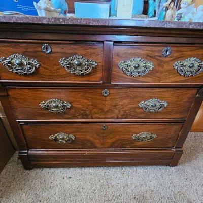 Marble topped chest of drawers with brass pulls and hardware