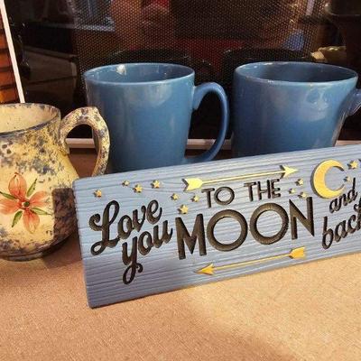 Ornamental sign, pitcher and coffee mugs