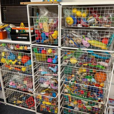 Storage Bins Full of Assorted Toys
- These storage bins are packed with a wide assortment of toys, from colorful plastic figures to...