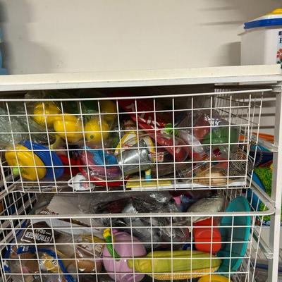 Storage Bins Full of Assorted Toys
- These storage bins are packed with a wide assortment of toys, from colorful plastic figures to...