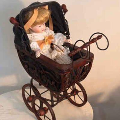Porcelain MANN Doll In A Wooden Stroller
