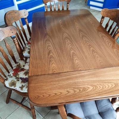 Large solid wood dining table with 6 chairs and 2 leafs