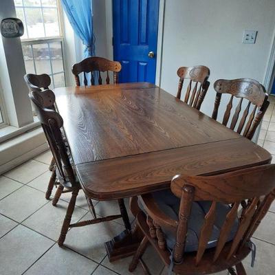 Large solid wood dining table with 6 chairs and 2 leafs