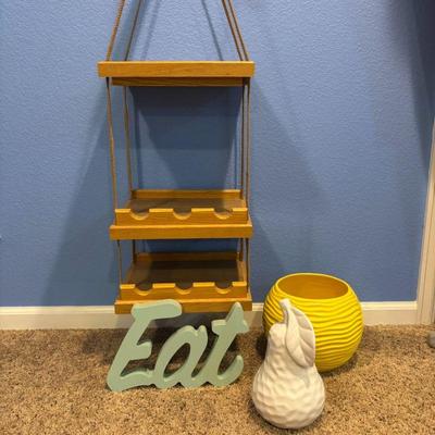 Lot #57 - Home Decor Lot - Hanging Wood Wine Rack, Yellow Ceramic Planter, White Ceramic Pear, and 'Eat' Sign.