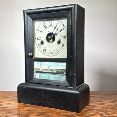 Seth Thomas Shelf Clock | Marked on the movement, ebonized wood case, enameled face with Roman numerals over a print of a steamer ship. -...