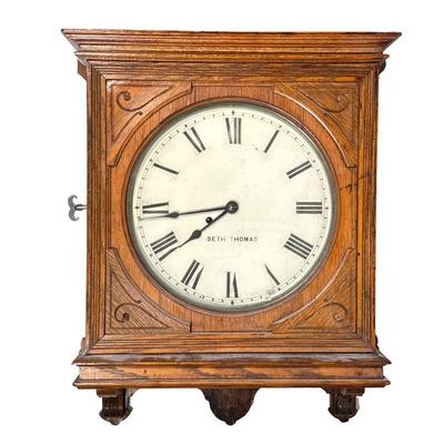 Seth Thomas Wall Clock | With Roman numeral markers, carved oak case. - h. 23 x w. 18.5 x d. 5.25 in

