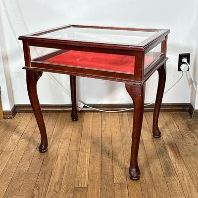 Display Table | A display case side table with glass sides and a hinged lift top, red interior. - h. 24 x w. 22 1/2 x d. 17 1/4 in

