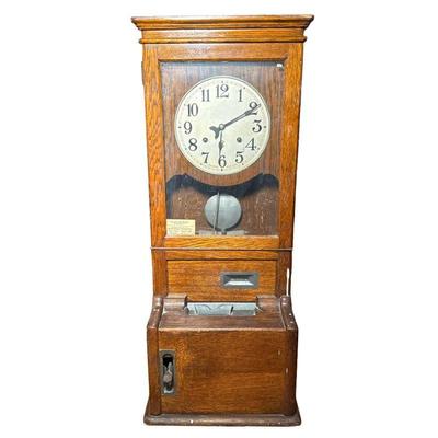 Cincinnati Time Recorder Clock | Cincinnati Ohio, USA, in an oak case, signed face with Arabic numerals. - h. 42.25 x w. 17.25 x d. 12.5...