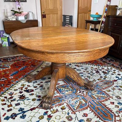 Oak Extension Dining Table | Carved solid oak, claw feet, round top, with three leaves (w. 9.75 in.); length with all three extensions...