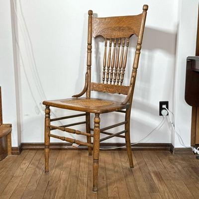 Carved Larkin Style Chair | Carved oak Larkin style dining or side chair with banister back over a caned seat, circa early 20th century....