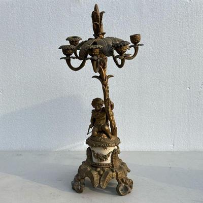 Brass Cupid Candleabra | Brass and stone candelabara with cupid figure at the base over scrolled foliate feet, with five carms. - h. 22 in

