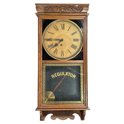 Ingraham Regulator Wall Clock | In a carved oak case, the face signed by the E. Ingraham Co., Bristol, Conn., having Roman numeral...