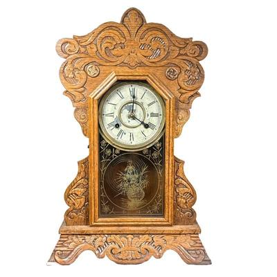 New Haven Carved Shelf Clock | An antique parlor mantle clock with ornate carved case, the face signed and with Roman numeral markers. -...