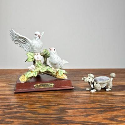 (2pc) Porcelain Figures | Including a Royal Carlton figural group of two birds on a stand, and a poodle with velvet cushioned back and...
