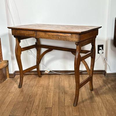 Antique Oak Desk Of Small Size | A small French style work table with slide out writing surface and single drawer, having curved legs and...