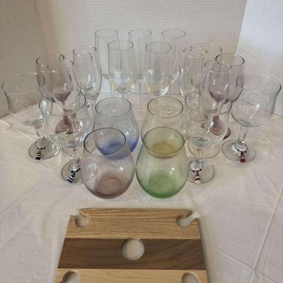 Collection of assorted wine glasses and wine bottle and glass holder