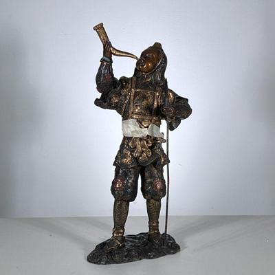 Gilt Bronze Samurai Figure | A Chinese bronze study of a Japanese or Chinese warrior in ornamental dress with horn and staff. - h. 19 x...