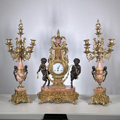 (3pc) Italian Imperial Clock Garniture | Intricate gilt metal and pink marble three piece clock garniture, comprising a large lyre and...
