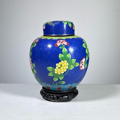 CLOISONNÉ GINGER JAR | Chinese cloisonné lidded ginger jar with floral decoration on a blue ground, with a carved wood stand. - h. 7.5 x...