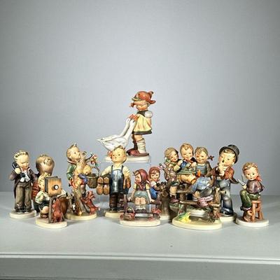 (13pc) Hummels Small & Medium | Small and medium Hummels, including children with umbrella, “Which Hand?” and “Duet” amongst others....