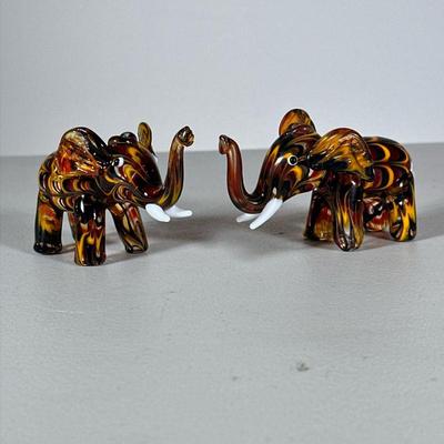 (2pc) Pair Glass Elephants | Blown feathered glass elephant figures in yellow and brown amber tones. - h. 2.5 x w. 4.25 in