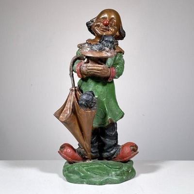 “CONTI” BRONZE CLOWN SCULPTURE, PUPPIES | The figure holding a hat and umbrella each with a puppy in it. - h. 17.5 in