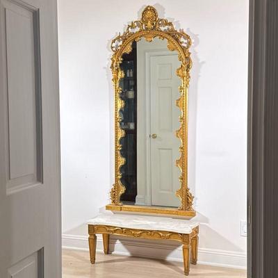 (2pc) GILT PIER MIRROR & MARBLE LOW CONSOLE | Two pieces, comprising an arch topped mirror with gilt scrollwork frame crested by a...