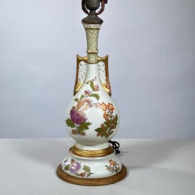 PORCELAIN PAINTED FLOWER LAMP | Antique porcelain double-handled vase mounted as a lamp, numbered on the bottom. - h. 15 x dia. 8 in...