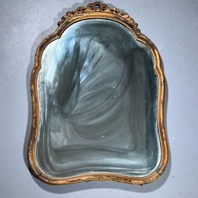 Gold Gilt Mirror | A very heavy mirror in a shaped carved wood frame. - h. 35.5 x w. 25.5 in