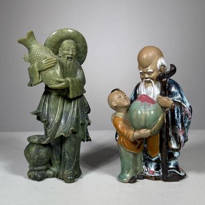 (2pc) Chinese Statues | Two Chinese figures including a carved stone man carrying fish, and an elder with staff and young boy, marked on...