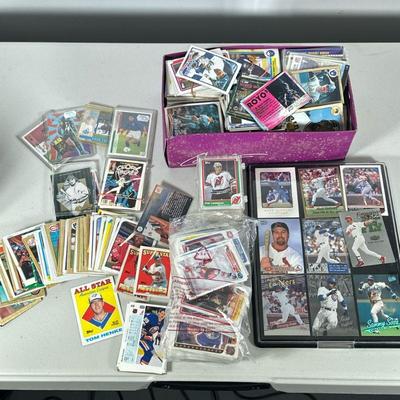 Baseball Card Collection | A large collection of baseball cards and other sports cards, some in protective cases, others loose.