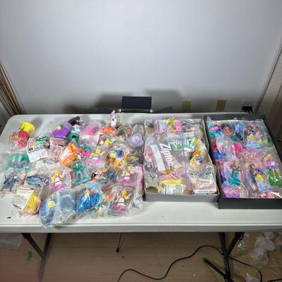 Happy Meal Toy Collection | A large collection of mostly new and unopened McDonald's happy meal toys, including some opened, plus...