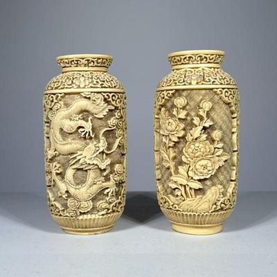 (2pc) Resin Covered Vases | A near pair: heavy, faux bone resin carved vases, one depicting a dragon on either side, the other with...