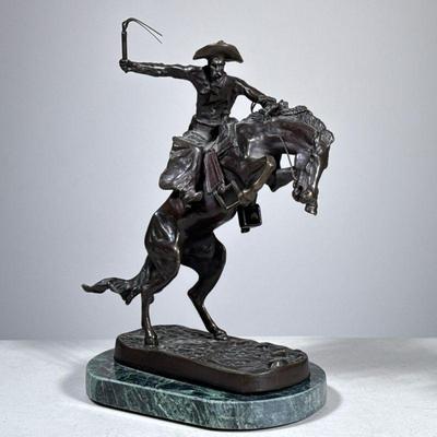 “Broncho Buster” Bronze | Cowboy atop a bucking horse, on a stone platform. Part of the Frederic Remington Bronze collection from the...
