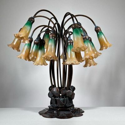 AFTER TIFFANY STUDIOS "HIGH POND LILLIES" TABLE LAMP | A 20th century copy, bronze base sprouting "flowers" with...