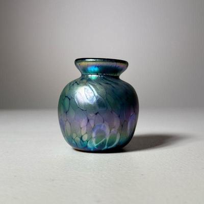 IRIDESCENT ART GLASS MINIATURE VASE, SIGNED A ALLISON | Small iridescent art glass vase with a rounded body and a flared lip. The surface...