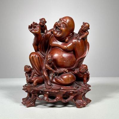 Carved Wood Buddha | Wooden laughing Buddha figure with bodhisattvas, continuously carved into a wood stand, the figures with inset eyes....
