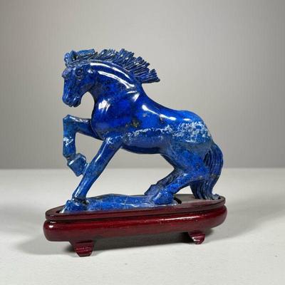Carved Lapis Horse | Carved blue lapis lazuli horse figure attached on a wood stand. - h. 6 x w. 2 x l. 5.5 in


