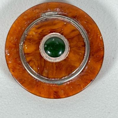 Art Deco Jade Compact | An unusual bakelite disc-form compact with a central inset jade cabochon. - dia. 3.25 in