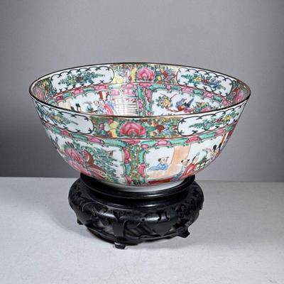 Famille Rose Bowl | Famille Rose porcelain center bowl decorated in Hong Kong, on a carved wood stand. - dia. 12 in

