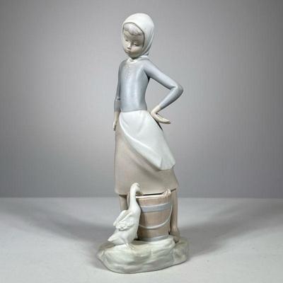 Lladro Girl With Duck | Lladro porcelain figure showing a girl performing chores with a duck drinking from bucket, marked on bottom. - h....