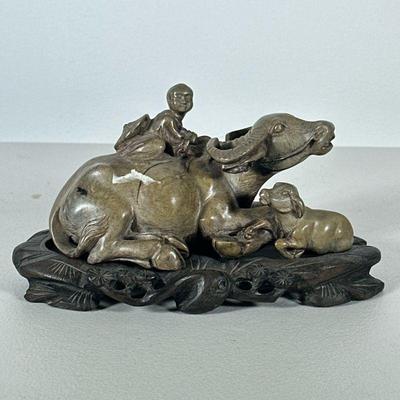 Chinese Soapstone Carving | Showing a child on a water buffalo, on a conforming carved stand. - h. 4.25 x l. 8 in (overall with stand)