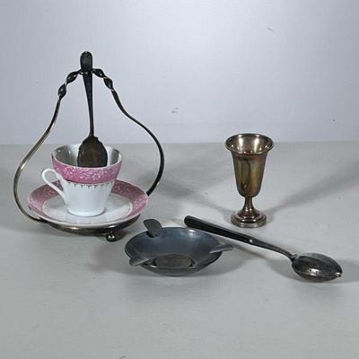 (4pc) Misc. Sterling Silver | Including a wood handled silver tea strainer spoon, a coin inset ashtray, a small weighted cup, and a...