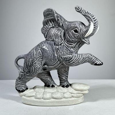 CERAMIC ELEPHANT FIGURE | A glazed ceramic elephant figure, with impressed numeral markers to underside. - h. 10.5 x w. 10 x d. 3.5 in

