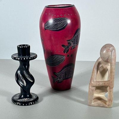 (3pc) Ethnographic Art | Including a pink vase with fish decoration, a black twisted candlestick holder, and a carved abstract figure. -...