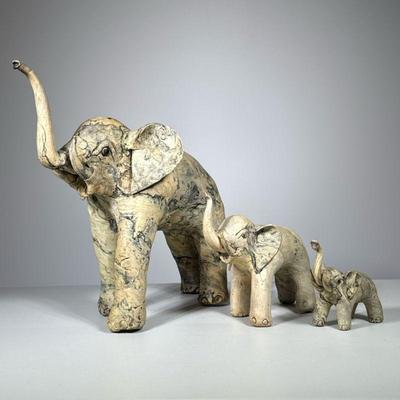 (3pc) Elephants | A set of three elephants of graduated size, made in the Philippines of possibly petrified wood or resin. - h. 14 x w. 8...