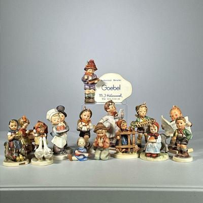 (15pc) Hummels | Variety of iconic Hummel figurines, including “School Boy”, "Little Pharmacist", a girl praying by carriage,...